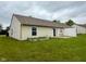 Exterior view of home with a well-maintained lawn, privacy fence, and sliding glass door at 509 Woodberry Dr, Danville, IN 46122