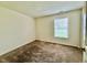 Bedroom featuring neutral carpet, a window and a door to the hallway at 509 Woodberry Dr, Danville, IN 46122
