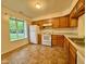 Functional kitchen featuring white appliances and wood cabinetry at 509 Woodberry Dr, Danville, IN 46122