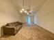 Spacious carpeted living room with neutral walls, ceiling fan, and sliding glass doors at 509 Woodberry Dr, Danville, IN 46122