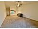 Open living room featuring carpet flooring and a ceiling fan at 509 Woodberry Dr, Danville, IN 46122