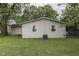 Exterior rear of home features vinyl siding and a well-manicured lawn with mature shade trees at 521 Elmhurst Pl, Whiteland, IN 46184
