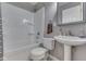 The bathroom features a shower-tub combination, pedestal sink, and decorative mirror at 521 Elmhurst Pl, Whiteland, IN 46184