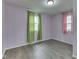 The bedroom has new flooring and two windows offering ample sunlight and a fresh breeze at 521 Elmhurst Pl, Whiteland, IN 46184