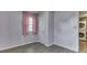 The bedroom has wood-look flooring and access to the in-unit washer and dryer at 521 Elmhurst Pl, Whiteland, IN 46184