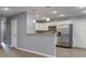 Open kitchen with stainless steel appliances, white cabinets, and a breakfast bar at 521 Elmhurst Pl, Whiteland, IN 46184