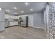 Open kitchen area with stainless steel appliances, white cabinets, and hard surface floors at 521 Elmhurst Pl, Whiteland, IN 46184