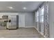 Bright kitchen with stainless steel appliances, white cabinets, and hardwood floors at 521 Elmhurst Pl, Whiteland, IN 46184