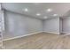 Bright, open living room with gray walls, light vinyl floors, and recessed lighting at 521 Elmhurst Pl, Whiteland, IN 46184