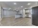 Spacious living room featuring hardwood floors, recessed lighting, and kitchen bar at 521 Elmhurst Pl, Whiteland, IN 46184