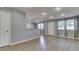 Bright open-concept living room featuring modern light fixtures, hard surface floors and neutral paint at 521 Elmhurst Pl, Whiteland, IN 46184