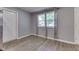 Bright living room featuring hardwood floors and large windows with beautiful backyard views at 521 Elmhurst Pl, Whiteland, IN 46184