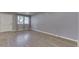 Bright living room with neutral walls, hard surface floors, windows and a white door at 521 Elmhurst Pl, Whiteland, IN 46184