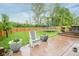Lush backyard featuring a patio, a trampoline, green grass, and a wood fence at 5374 John Quincy Adams Ct, Plainfield, IN 46168