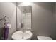 Simple powder bathroom with a pedestal sink, a mirror, and neutral paint at 5374 John Quincy Adams Ct, Plainfield, IN 46168