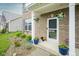 Charming brick home entrance with hanging flower baskets at 5374 John Quincy Adams Ct, Plainfield, IN 46168