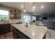 Modern kitchen island with granite countertop, stainless steel appliances, and an open layout to the living room at 5374 John Quincy Adams Ct, Plainfield, IN 46168
