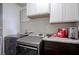 Laundry area with stainless steel washer and dryer and upper cabinets at 5374 John Quincy Adams Ct, Plainfield, IN 46168