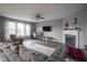 Spacious living room with a fireplace, comfortable seating, and large windows for natural light at 5374 John Quincy Adams Ct, Plainfield, IN 46168