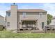 Home's backyard featuring a covered patio with outdoor seating and a built-in grill at 5671 Glass Chimney Ln, Indianapolis, IN 46235