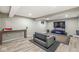 Spacious finished basement with a sofa, television, and modern flooring at 5671 Glass Chimney Ln, Indianapolis, IN 46235