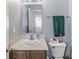Cozy bathroom featuring single sink vanity, toilet, and tiled floors at 5671 Glass Chimney Ln, Indianapolis, IN 46235