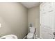 Compact half-bathroom with a toilet and simple decor, offering essential amenities at 5671 Glass Chimney Ln, Indianapolis, IN 46235