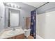 Cozy bathroom featuring single sink vanity, toilet, and shower with curtain at 5671 Glass Chimney Ln, Indianapolis, IN 46235