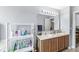 Bathroom featuring a double sink vanity and convenient shelving for storage at 5671 Glass Chimney Ln, Indianapolis, IN 46235
