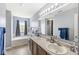 Bright bathroom featuring double sinks, a soaking tub under the window, and neutral walls at 5671 Glass Chimney Ln, Indianapolis, IN 46235