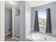 Comfortable bathroom featuring a soaking tub and tiled floors at 5671 Glass Chimney Ln, Indianapolis, IN 46235