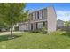 Charming two-story home featuring a well-maintained lawn and a mature tree, perfect for Gathering living at 5671 Glass Chimney Ln, Indianapolis, IN 46235