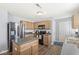The modern kitchen has stainless steel appliances, wood cabinetry, and a functional island. Eat in kitchen at 5671 Glass Chimney Ln, Indianapolis, IN 46235