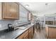 Open concept kitchen with sleek appliances, wood cabinets, and a large sink, perfect for modern living and cooking at 5671 Glass Chimney Ln, Indianapolis, IN 46235