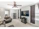 Inviting living room area with a large TV, cozy seating, and ample natural light at 5671 Glass Chimney Ln, Indianapolis, IN 46235