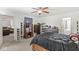 Comfortable main bedroom featuring neutral decor, an overhead fan, television, and carpeted floors at 5671 Glass Chimney Ln, Indianapolis, IN 46235