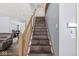 Inviting staircase featuring wooden steps and railings, connecting different levels of the home at 5671 Glass Chimney Ln, Indianapolis, IN 46235