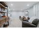 Finished basement with carpet, gray walls, a leather armchair and sofa at 60 E Poplar St, Zionsville, IN 46077