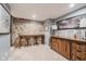 Finished basement with a stone wall, wooden table with stools, and a wooden console at 60 E Poplar St, Zionsville, IN 46077