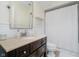 Cozy bathroom featuring dark wood vanity, white tile, and shower with curtain at 60 E Poplar St, Zionsville, IN 46077