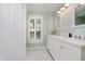 Bright bathroom with double vanity, white cabinets, and shower with a glass window at 60 E Poplar St, Zionsville, IN 46077