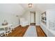 Bonus room has hardwood floors, built in shelving, an armchair, and table with chairs at 60 E Poplar St, Zionsville, IN 46077