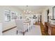 Elegant dining room with hardwood floors, bright lighting, and a view into the modern kitchen at 60 E Poplar St, Zionsville, IN 46077