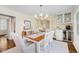 Elegant dining room featuring a chandelier, hardwood floors, and access to a built-in bar at 60 E Poplar St, Zionsville, IN 46077
