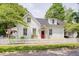 Charming two-story home with a red front door, white picket fence, and well-manicured lawn at 60 E Poplar St, Zionsville, IN 46077