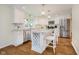 Bright kitchen featuring white cabinets, granite countertops, and a stainless-steel refrigerator at 60 E Poplar St, Zionsville, IN 46077