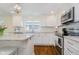 Charming kitchen featuring white cabinets, stainless steel appliances, and granite countertops at 60 E Poplar St, Zionsville, IN 46077
