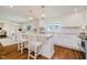 Bright, updated kitchen with white cabinets, island seating, and stainless steel appliances at 60 E Poplar St, Zionsville, IN 46077
