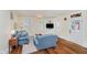 Inviting living room with hardwood floors, blue sofas, and natural light from shuttered windows at 60 E Poplar St, Zionsville, IN 46077