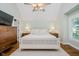 Bright bedroom featuring a ceiling fan, wood floors, and neutral decor at 60 E Poplar St, Zionsville, IN 46077
